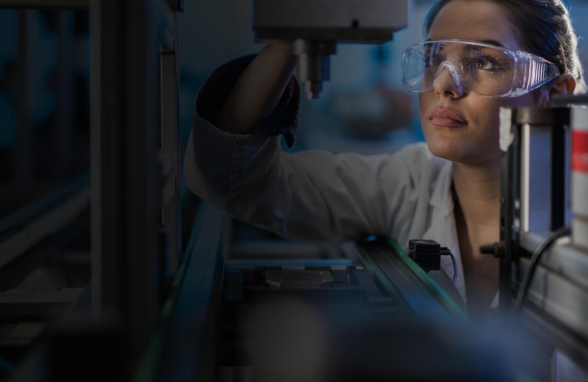 Scientist operating laboratory machinery