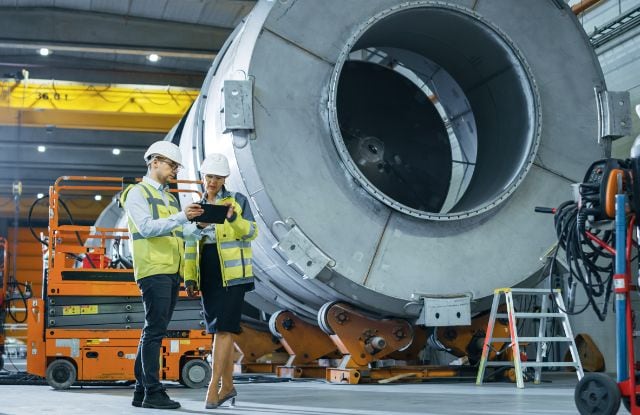 Engineers discuss part design on the factory floor