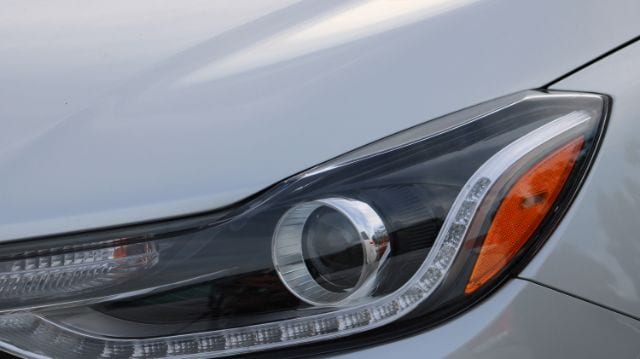 Headlight and hood components of a commercial passenger vehicle