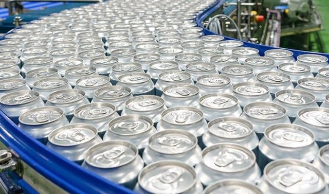 Conveyor belt made from blue food safe plastic in a beverage manufacturing facility 