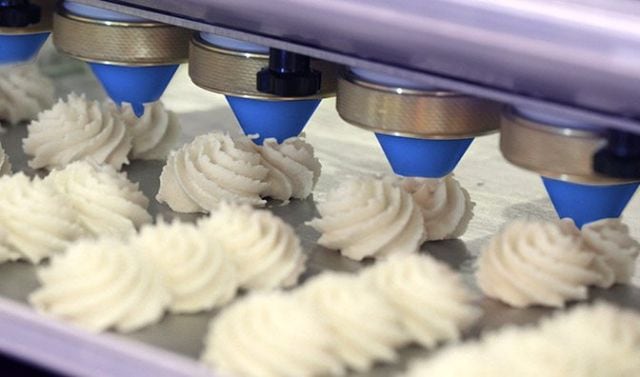 Icing nozzles made from blue food safe plastic in a food manufacturing facility