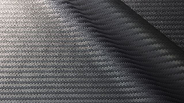 A sheet of woven carbon fiber textile material