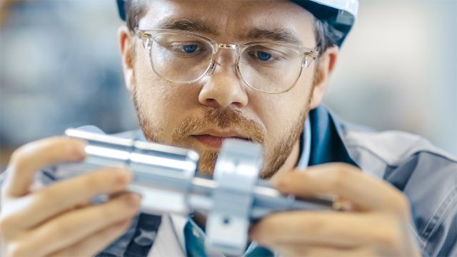 An engineer examining the design of a part