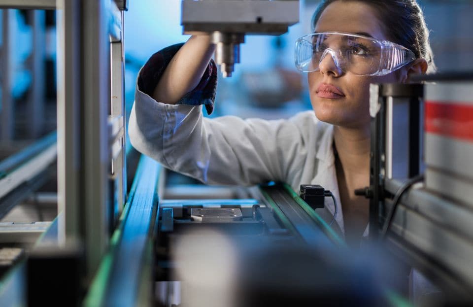 Scientist operating laboratory machinery