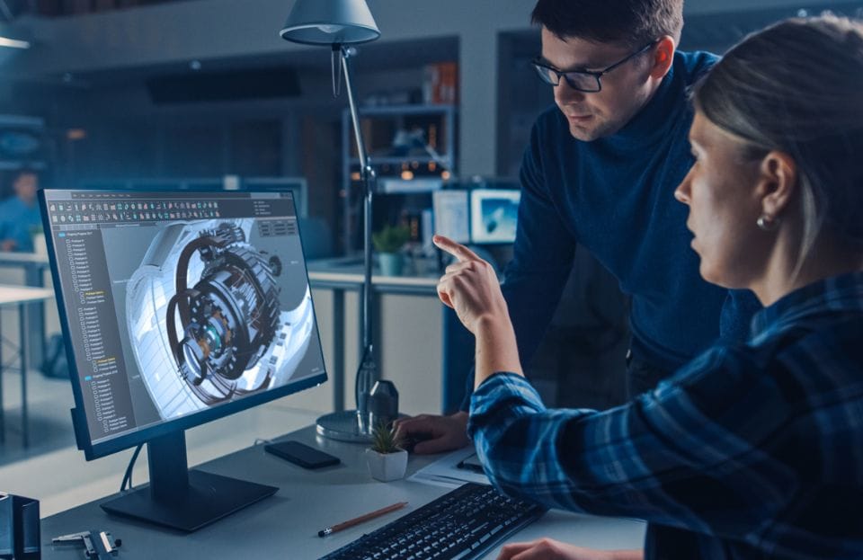 Engineers designing a turbine with 3D CAD tools