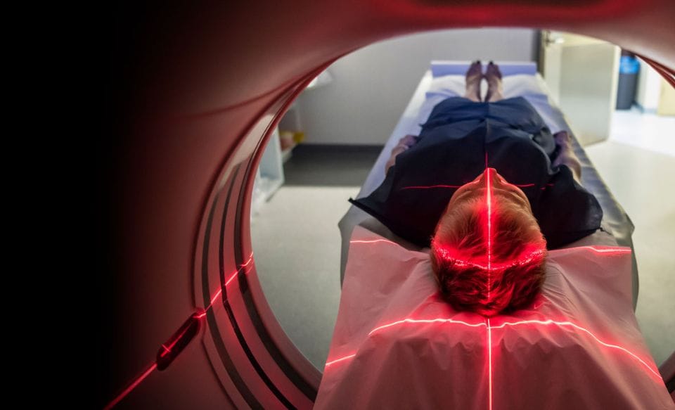 A patient entering a CT scanner