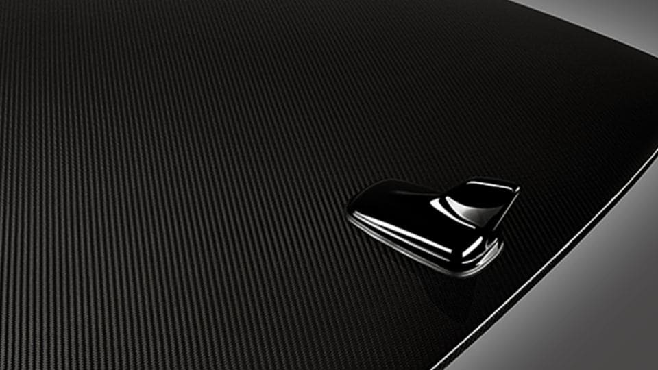 Glossy surface of a finished car body panel reinforced with advanced carbon fiber materials.