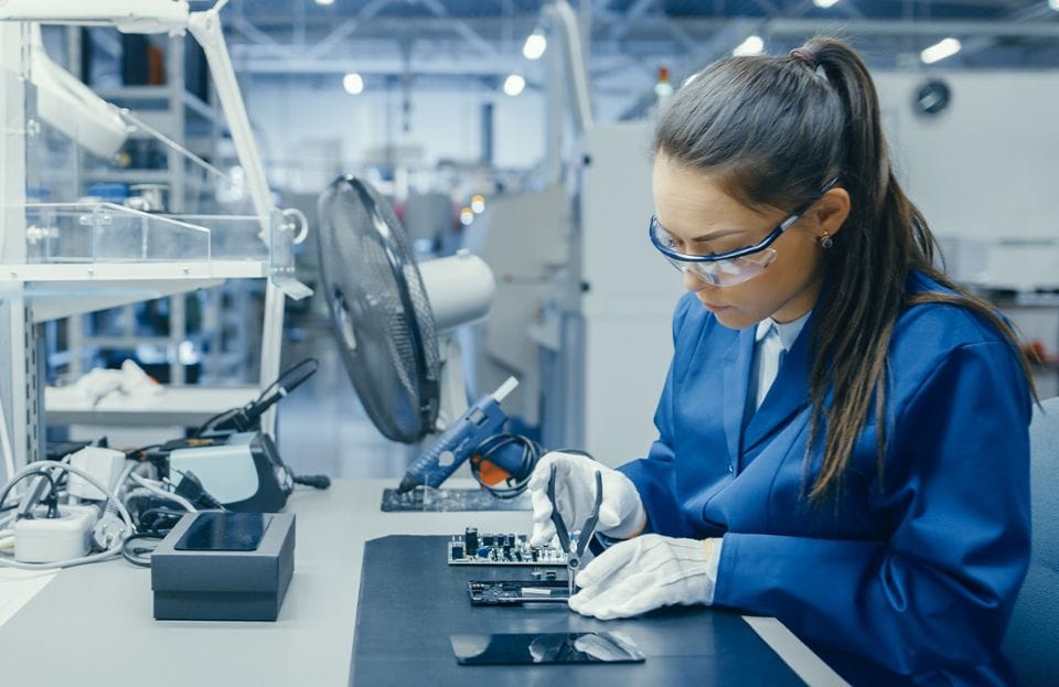 Employee assembling an electronic device